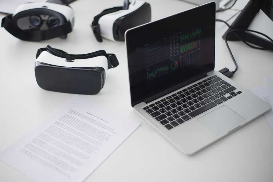 Modern workspace featuring laptop and VR headsets, ideal for tech themes.