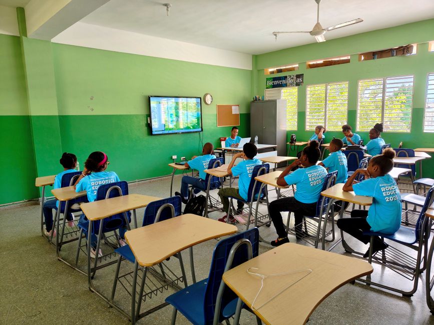 Students engage in a digital learning session in a bright, modern classroom with educational technology.